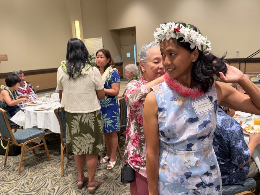 State Rep. Della Au Belatti receives a lei at the Hawaiʻi Democratic Party's post-primary election unity breakfast on Sunday, Aug. 9, 2026. 
