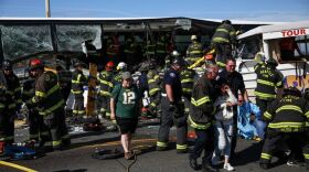 First responders care for victims after a charter bus was struck by a duck amphibious vehicle Thursday on the Aurora Bridge. See more photos at seattlepi.com