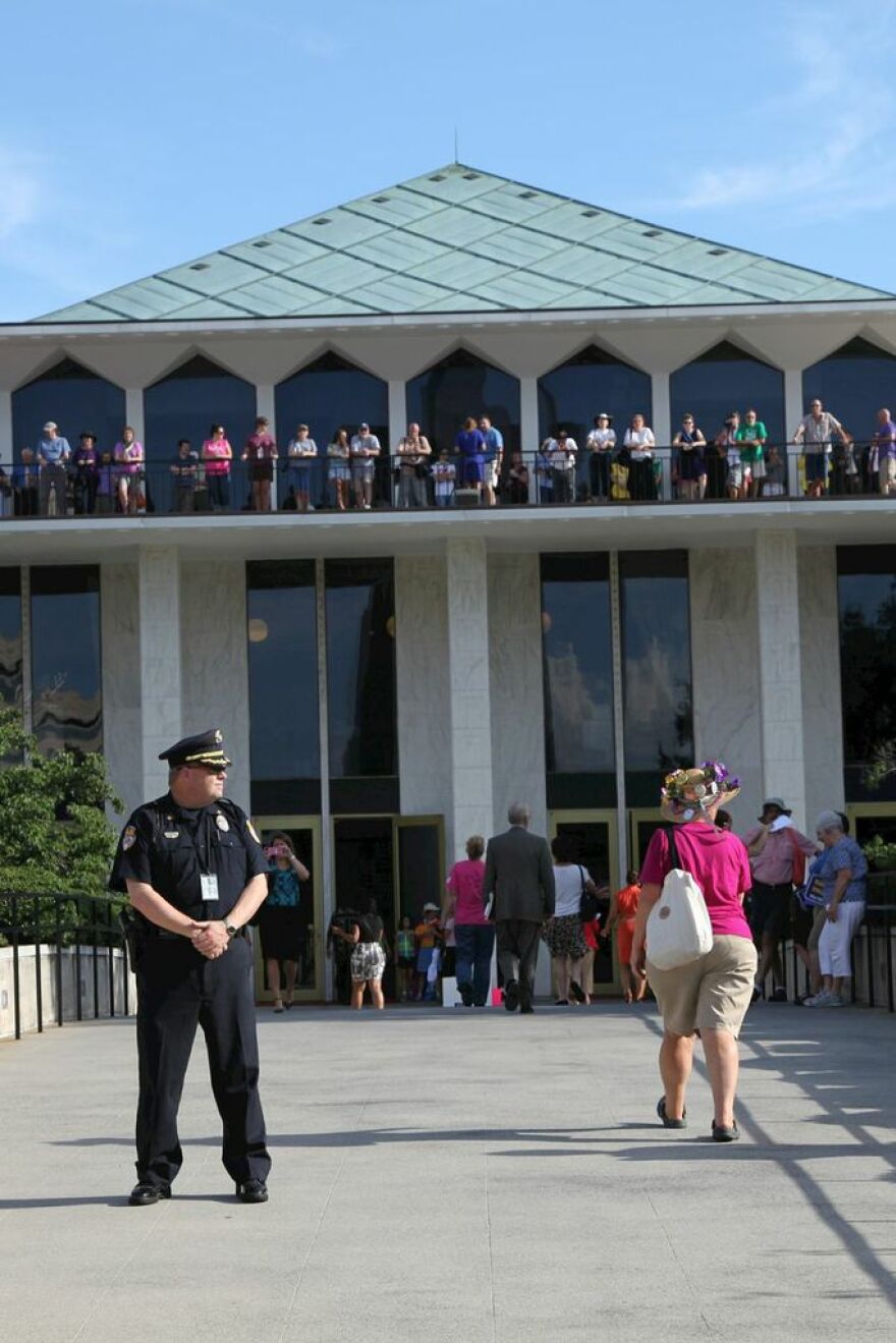 Police stand outside the capitol during a Moral Mondays protest.