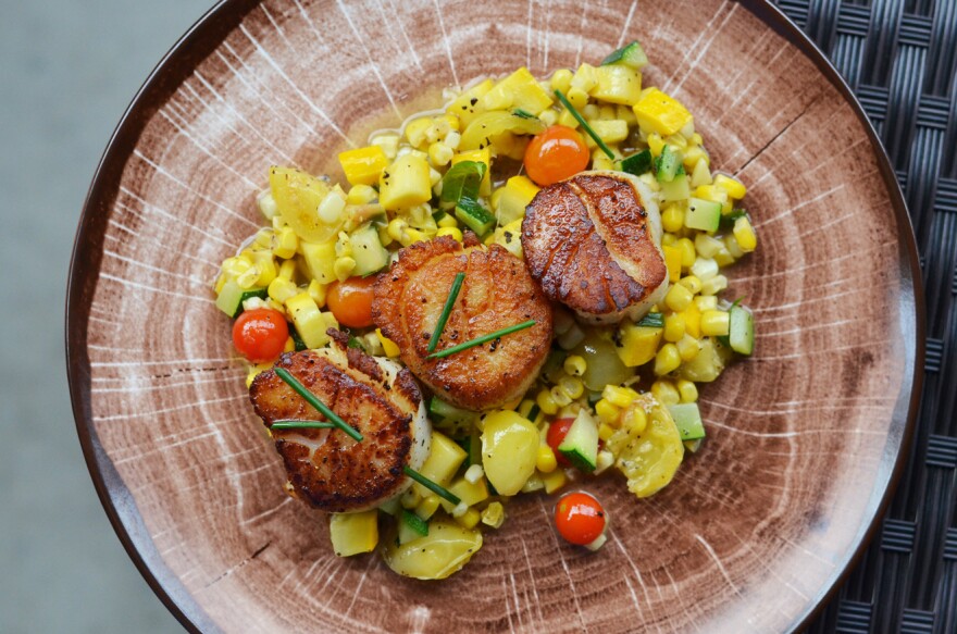Sauce recommends the the seared scallop dish on a bed of chopped summer squash, corn, tomato and lemon verbena from Bakers & Hale in Godfrey, Illinois.