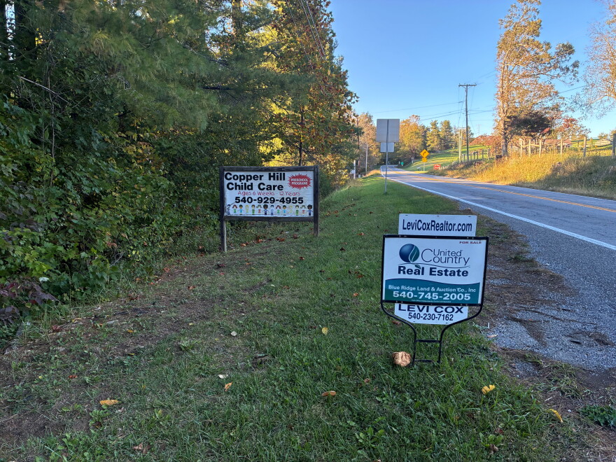 Sign outside Copper Hill Child Care facility in Floyd County, with a for sale sign outside. 