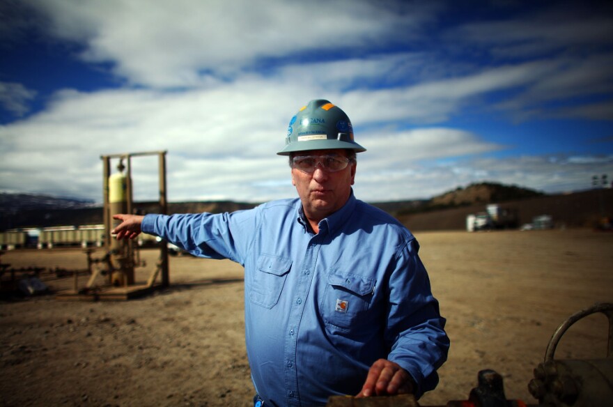 Mark Balderston, an engineer with Encana, a natural gas producer, points to a well pad completion site near Rifle, Colo.