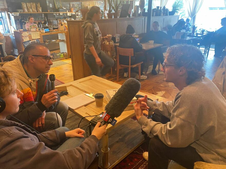 Morning Edition host A Martinez (L) speaks with Dordt University junior Carter King (R) about next year's presidential election. The Morning Edition team met with King, who is originally form Austin, Texas, at The Fruited Plain Café in Sioux Center, Iowa.