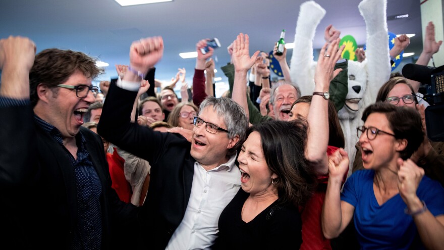 Members and supporters of the Greens coalition celebrate in Berlin after the announcement of the first forecast for the European elections.