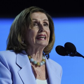 A woman speaks into a microphone.