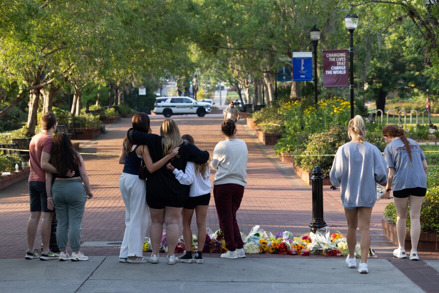 Mourners at a makeshift memorial on the Florida State University campus in Tallahassee, following a shooting that left at least six people injured on April 17, 2025. Two people were killed and six wounded at Florida State University on Thursday, when a student Ñ identified as the son of a sheriffÕs deputy Ñ opened fire near the student union building, investigators said. (Erich Martin/The New York Times)