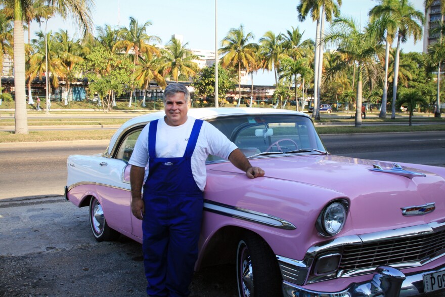 Julio Alvarez standing in front of Lola, a 1956 Chevy Bel Air.