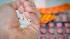 A stock image of a handful of pills