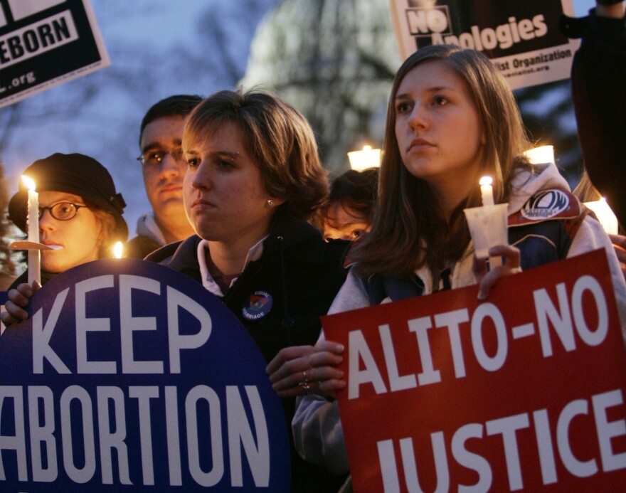 Larissa Mariano, left, and Annika Carlson, right, both 20 years-old, and both from Hope College in Holland, Mich., take part in the pro-choice candlelight vigil infront of the Supreme Court Building, Jan. 22, 2005 in Washington. It was 33-years ago today that the Supreme Court decision of Roe versus Wade made abortion legal. (AP Photo/Pablo Martinez Monsivais)