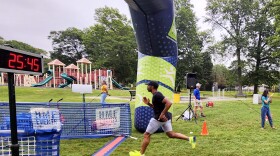 FILE: Alex Brown crosses the finish line at the MOVE!5K and Movement Festival at Keney Park in Hartford Connecticut June 12, 2025.