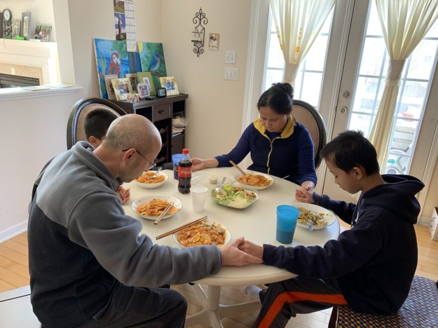 Cary residents Rong Cai and Yanshun Liu pray with their two sons February 22. It was the first Saturday the family had spent together since Cai returned from visiting her parents in Southern China and self-quarantined for 14 days upon arriving back in the U.S. 