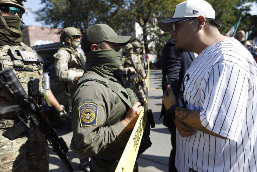 Residents of Chicago's Brighton Park neighborhood confront U.S. Customs and Border Protection (CBP) agents at a gas station after Immigration and Customs Enforcement (ICE) agents allegedly detained an unidentified man riding in his car, in Chicago, Illinois, on October 4, 2025. (Octavio Jones/AFP via Getty Images)
