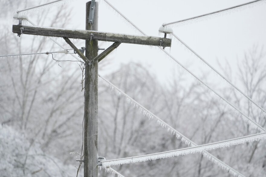 Ice covers lines on a utility pole during a winter storm Sunday, Jan. 25, 2026, in Nashville, Tenn.