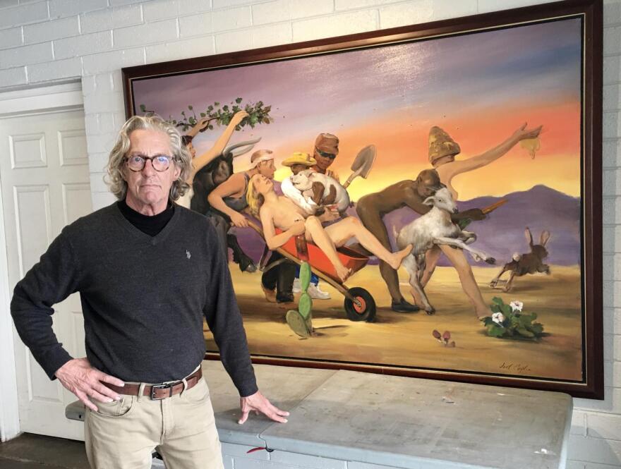 man next to painting