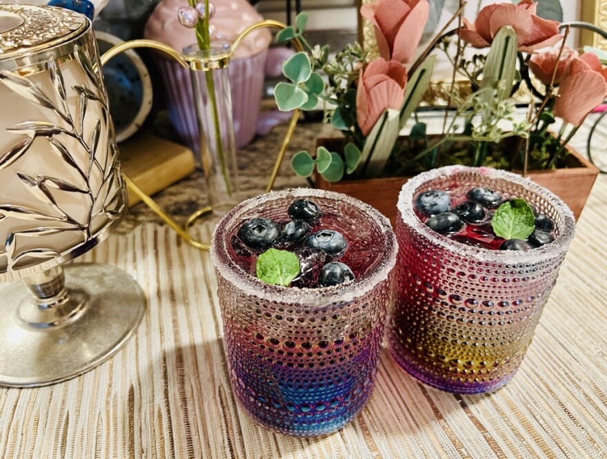 A picture of two glasses of blueberry mocktails.