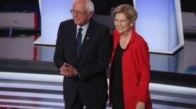 Democratic presidential candidates Sen. Bernie Sanders and Sen. Elizabeth Warren take the stage at the beginning of the Democratic Presidential Debate in Detroit, Michigan. (Justin Sullivan/Getty Images)