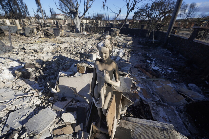 A burnt statue sits amid the rubble of a home, Saturday, Aug. 12, 2023, in Lāhainā, Hawaiʻi.