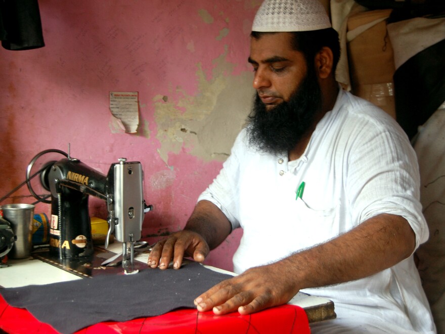 Mohammed Arif makes custom rickshaw seat covers at a market in Delhi that serves as a one-stop shop for the city's rickshaw drivers.