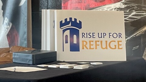 Lawn sign featuring the logo for Church World Service's new initiative Rise Up for Refuge on display at community meeting held at The Eagle's Dare in Wilmington.