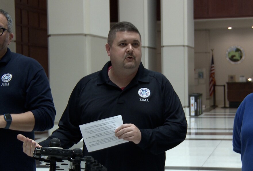 Craig Browning with the Federal Emergency Management Agency speaks at a podium.