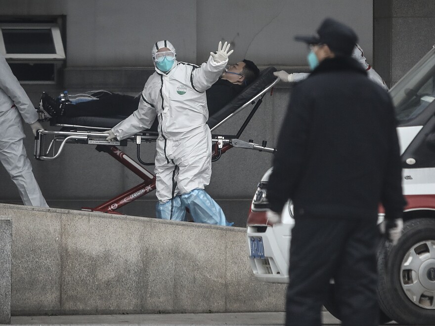 Staff members transfer patients to Jin Yintan hospital in Wuhan on Jan. 17, 2020.