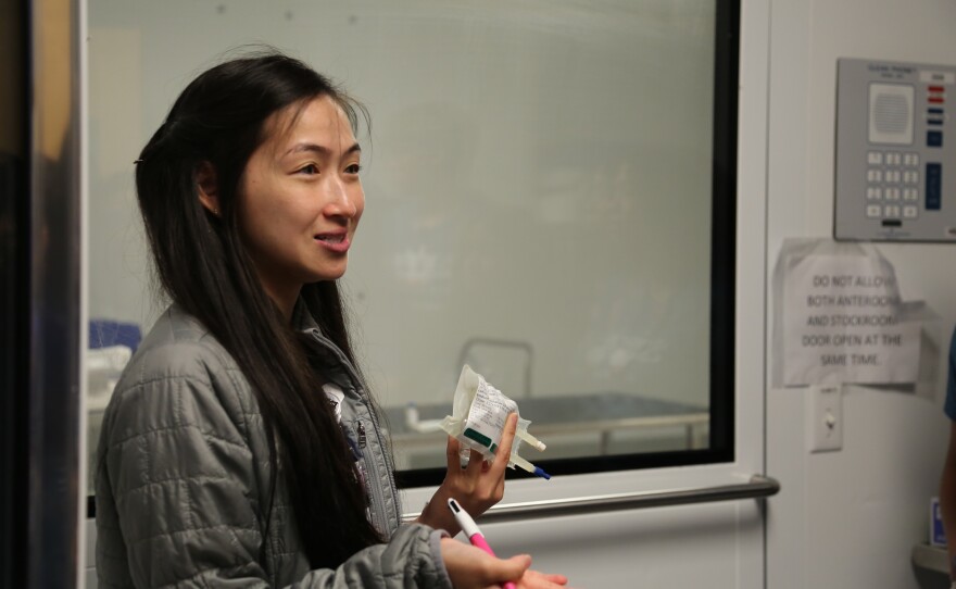 Leyah Nguyen, a pharmacy resident at Onvida, held up an antibiotic that's regularly stored in the clean room behind her.