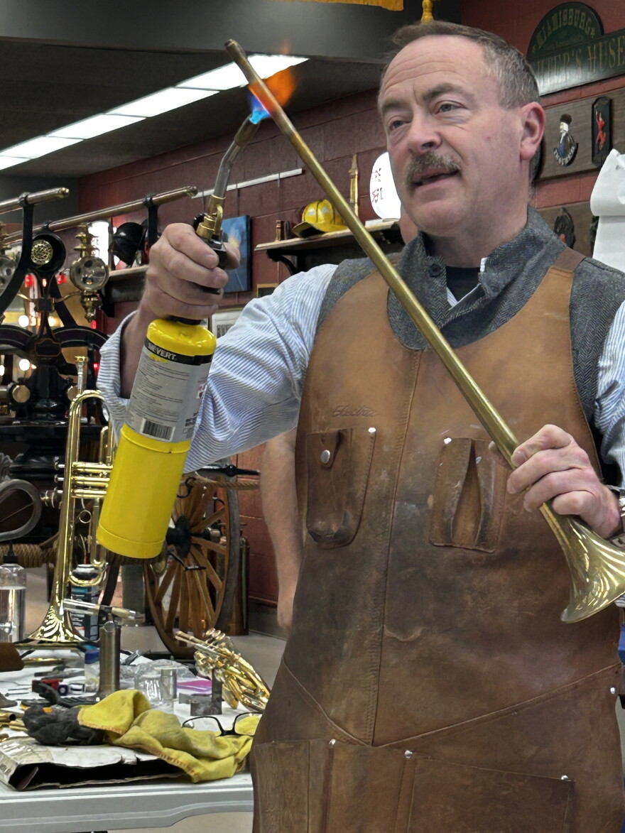 Pictured here is custom instrument maker George Schlub demonstrates the annealing process he uses in crafting his instruments.
