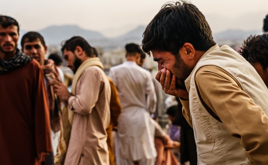 A man weeps during a mass funeral for members of a family was killed in a U.S. drone strike, in Kabul, Afghanistan, on Monday.