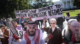A protester dressed as Saudi Arabian crown prince Mohammad bin Salman, demonstrates with members of the group Code Pink outside the White House in the wake of the disappearance of Saudi Arabian journalist Jamal Khashoggi October 19, 2018 in Washington, DC. (Win McNamee/Getty Images)