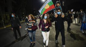 A boy holds a Mapuche indigenous flag as people celebrate while waiting for the official results of the referendum for a new constitution in Santiago, Chile. The approval for the new constitution won with 78% of the votes. After months of protests, Chileans voted between writing a new charter or keeping the existing constitution that was drawn up during the Augusto Pinochet dictatorship. 
