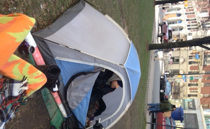 Occupy member Chris Phillips of Buffalo sits in his tent at Lafayette Square