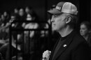 A black and white image of Bob Odenkirk wearing an SIU hat during a speaking engagement at SIU