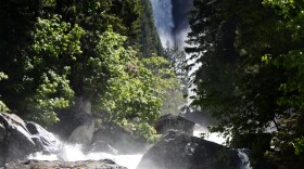 Vernal Fall is seen in the background as the Merced River surges toward Yosemite Valley in June 2011.