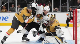 Chicago Blackhawks' Jordan Greenway (12) falls into Vegas Golden Knights goaltender Carter Hart (79) during the first period of an NHL hockey game Tuesday, Sept. 29, 2026, in Las Vegas. (AP Photo/John Locher)
