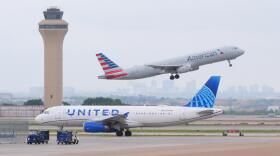 An American Airlines jet takes off as an United Airlines jet taxis at DFW International ⁦Airport in Grapevine, Texas, Tuesday, April 14, 2026. (LM Otero/AP)