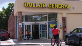 FILE - Children ride their bicycles to the Dollar General store, Aug. 21, 2025, in Nashua, N.H. (AP Photo/Charles Krupa, File)