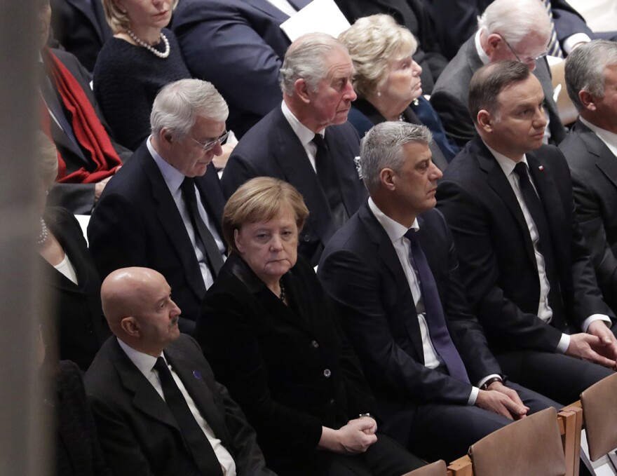 Britain's Prince Charles, second from left, back row, and German Chancellor Angela Merkel, second from left, bottom row, are shown seated during a State Funeral for former President George H.W. Bush at the National Cathedral, Wednesday, Dec. 5, 2018.