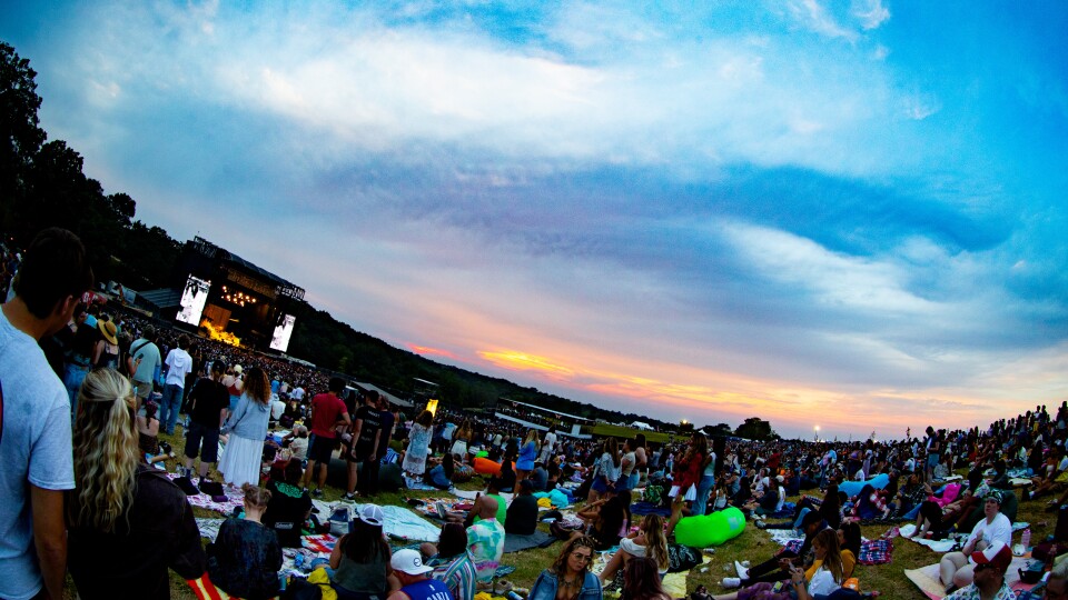 a large crowd of people watching a musical performance 