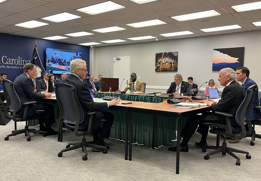 Treasurer Curtis Loftis speaks with Gov. Henry McMaster during the State Fiscal Affairs Authority meeting in March 31, 2026.