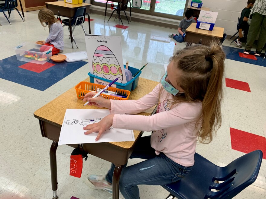 Aunabella Hughes’ desk is a careful six feet from the next one. Though guidelines now allow children to sit closer together, teacher Tammy Mishak says they’ve established a routine the children are all comfortable with