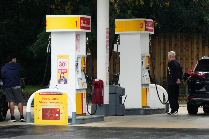 Customers check gas price while they fill up their vehicle's tank at a gas station in Arlington Heights, Ill., Wednesday, Sept. 30, 2026. (AP Photo/Nam Y. Huh)