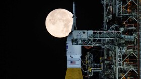 A full moon is seen shining over NASA’s SLS (Space Launch System) and Orion spacecraft, atop the mobile launcher in the early hours of Sunday, Feb. 1, 2026, at NASA’s Kennedy Space Center in Florida. (Sam Lott/NASA via AP)