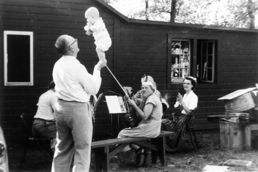 Anton Kratochvil or "grandpa Tony" balances baby Gary at a gathering with family.
