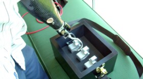 Stephen Shope picks up one of the tools in the new toolkit for the handless. vspace=4 align=left