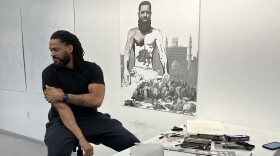 Male artist sits in his studio