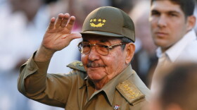 FILE - Cuba's acting President Raul Castro waves to journalists in front the Museum of the Revolution in Havana on March 13, 2007. 