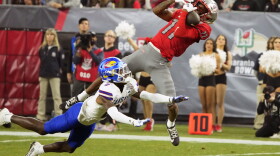 FILE - UNLV wide receiver Ricky White makes the catch over Kansas cornerback Cobee Bryant (2) during the second half of the Guaranteed Rate Bowl NCAA college football game Tuesday, Dec. 26, 2023, in Phoenix. (AP Photo/Rick Scuteri, File)