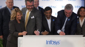 State and local officials along with Infosys company leaders sign a beam commemorating the progress to its U.S. Educational Center in Indianapolis.