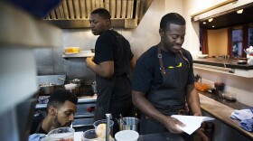 Edouardo Jordan, right, works in the kitchen at JuneBaby on Wednesday December 6, 2017, in Seattle. 