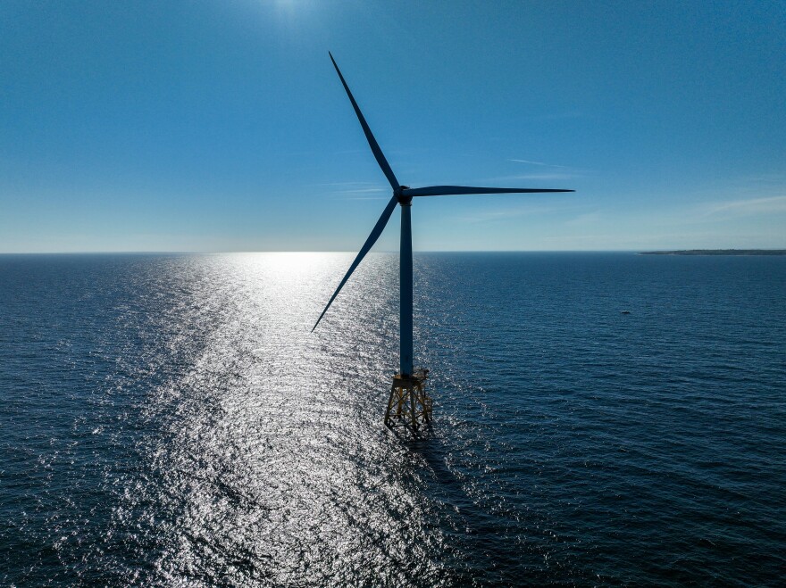 A wind turbine with three blades is standing in the Atlantic Ocean.